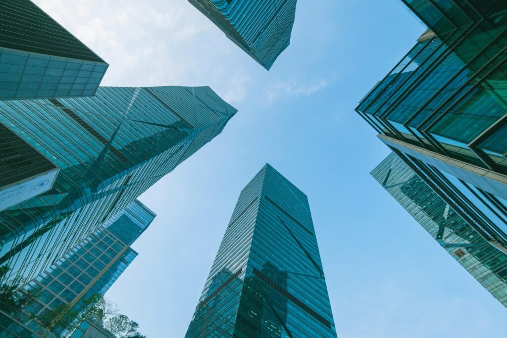 Low angle view of contemporary skyscrapers in Shenzhen, China under a clear blue sky.